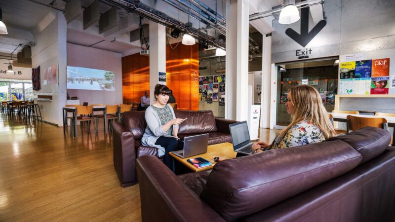 Cafe interior with two people having a creative meeting
